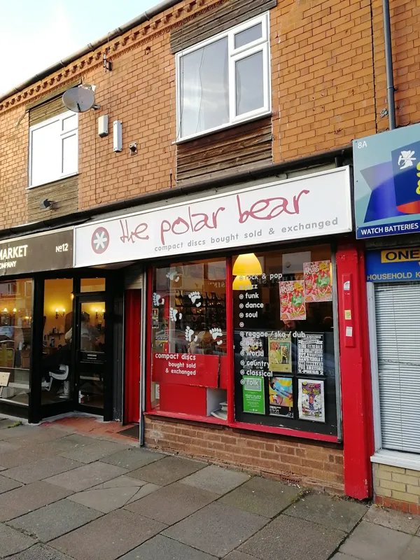 The polar bear painted shopfront sign at 10 York Road, white facade, red lettering
